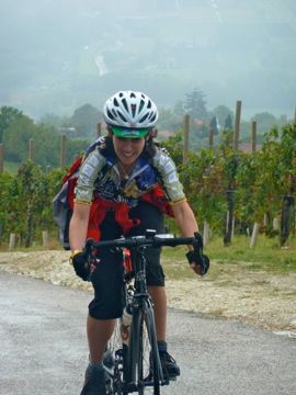 bike tours italy femaie biker in vineyard